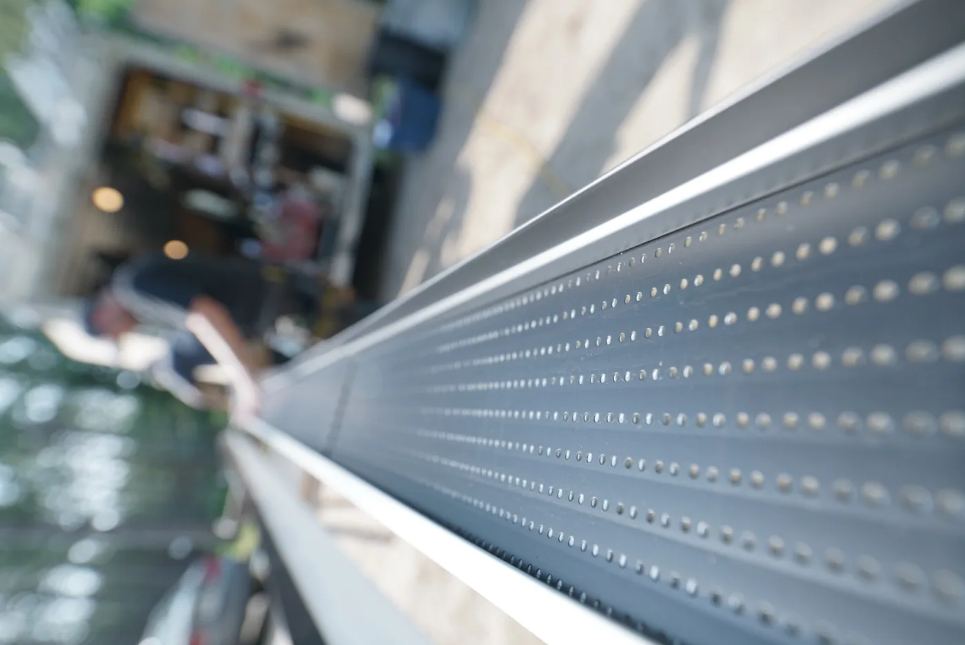 Long view along a continuous perforated aluminum gutter protection profile