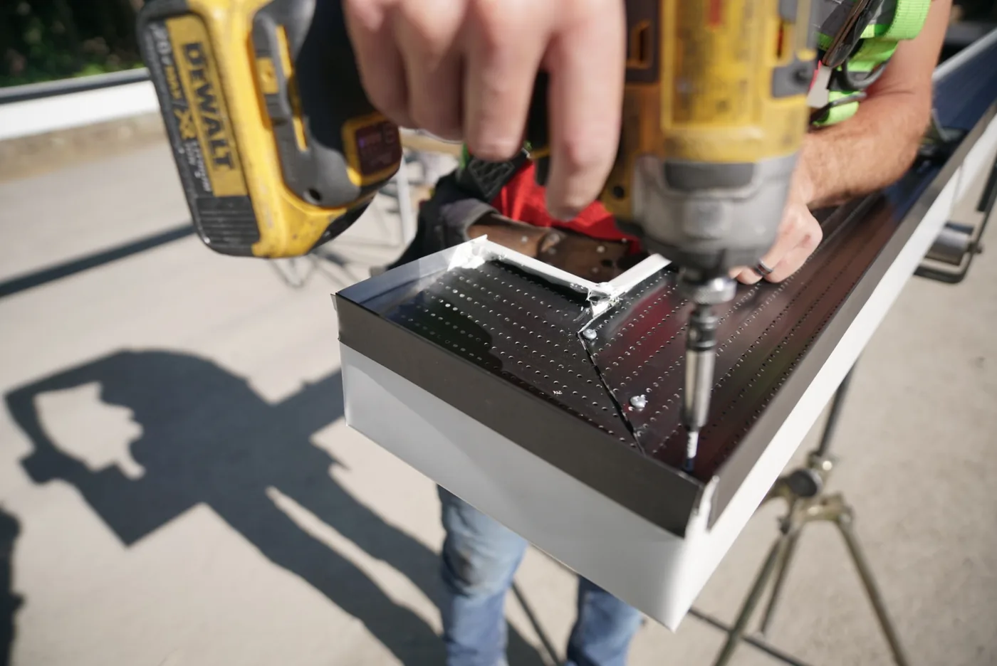 Manufacturer installation close-up fastening a continuous gutter protection profile