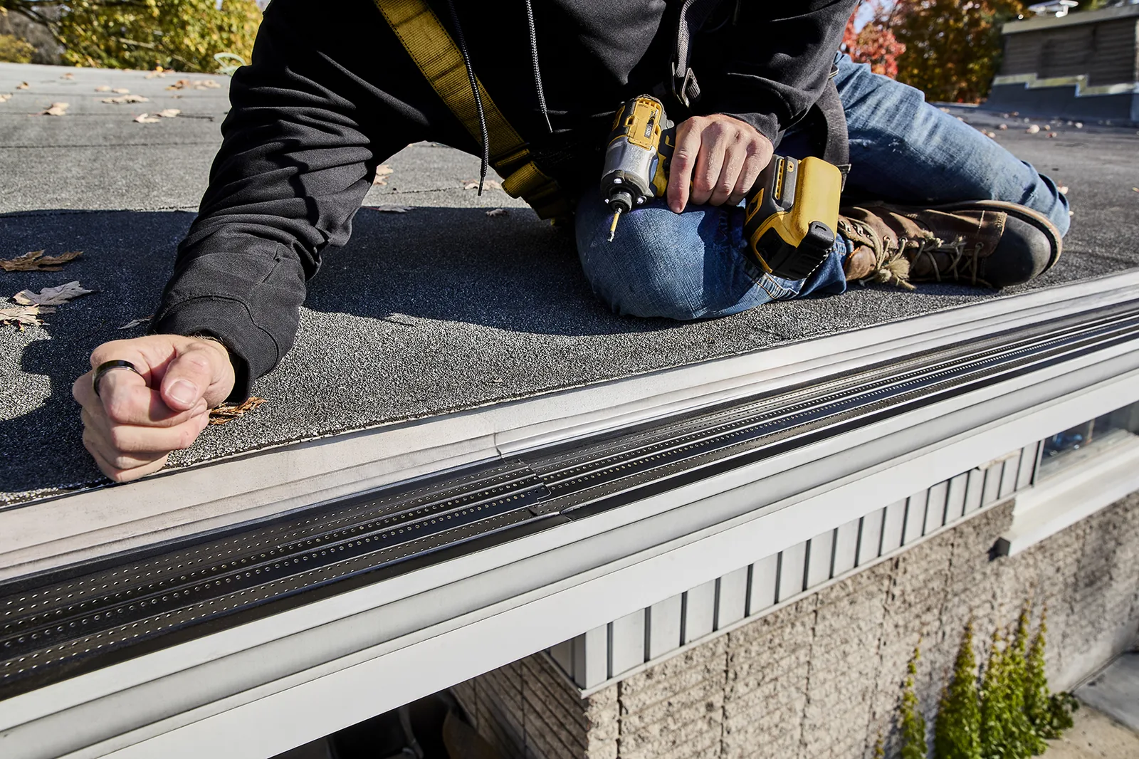 Manufacturer installation photo showing gutter protection being fastened