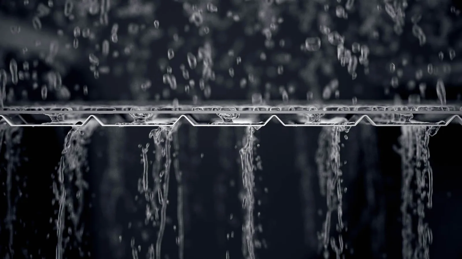 Water flowing through DoublePro perforated aluminum gutter protection