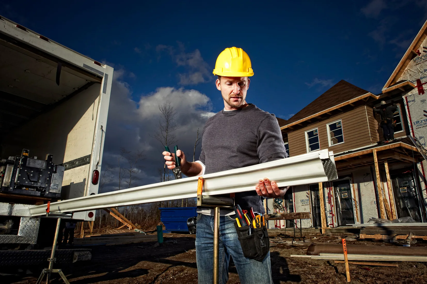 Manufacturer gutter preparation image with a gutter section on forming stands