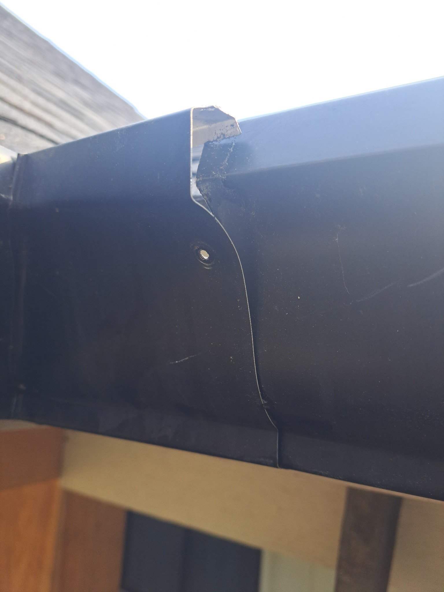 Field example showing seam, overlap, and hanger detail concerns on a gutter system not installed by McCloud Gutter.
