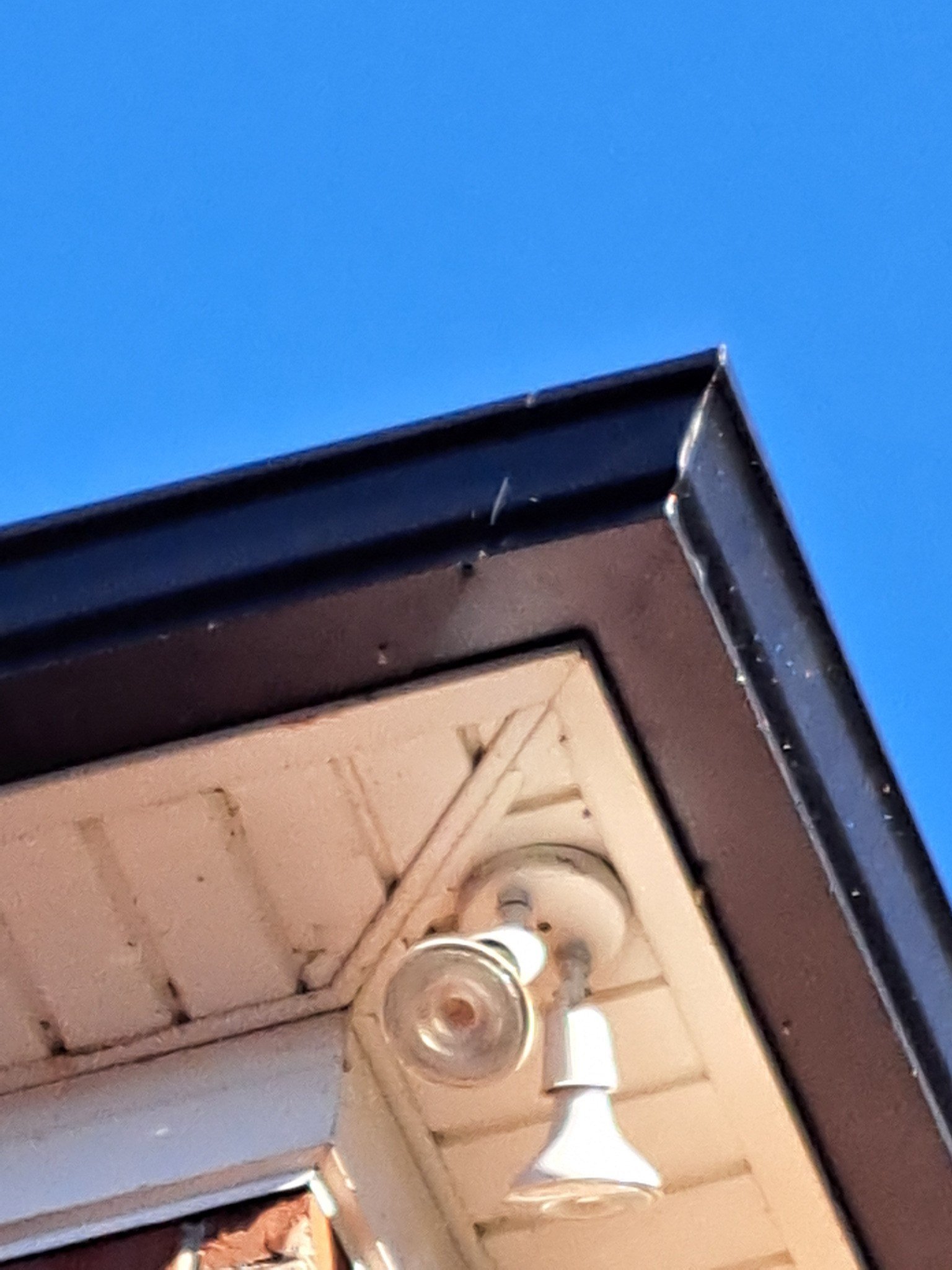 Field example showing a patched straight run where a seamless gutter appears to have been cut short on a system not installed by McCloud Gutter.