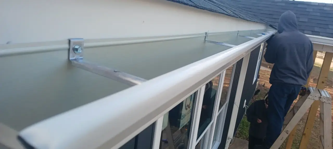 White seamless gutter being installed by McCloud Gutter