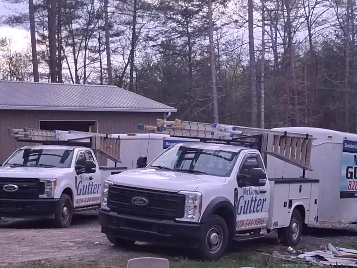 Two McCloud Gutter trucks and gutter trailer